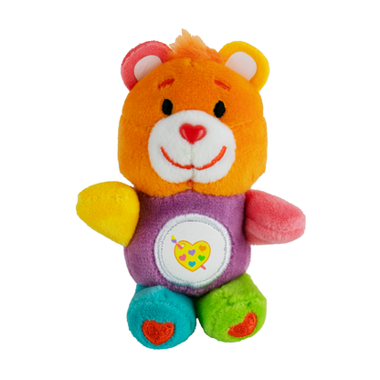 A bright and colorful Care Bear plush with a heart-shaped rainbow paint palette on its tummy called Work of Heart Bear