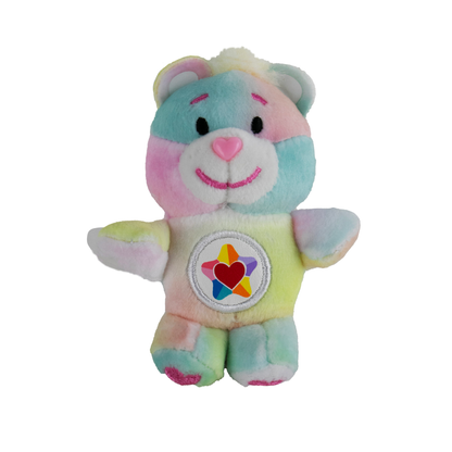 A tiny pastel multi-colored Care Bear plush with a star and a heart on its tummy called True Heart Bear