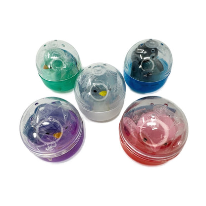 5 colorful gachapon capsules filled with penguin toys. 