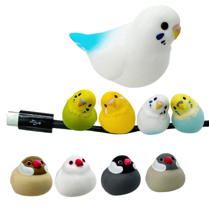 Eight tiny toy bird figures that can sit on a charging cable. Includes parakeets and sparrows.