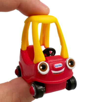 A hand hold a Miniverse Mini Little Tikes Surprise Toy Car Cozy Coupe