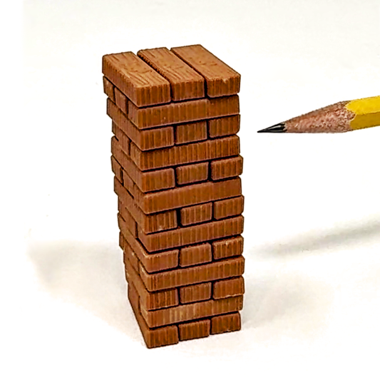 A pencil is used to play The World's Smallest Jenga