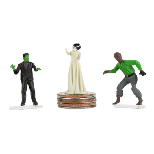 3 Micro Universal Monster Figurines: Frankenstein, Bride of Frankenstein standing on a stack of quarters, and The Wolf Man.