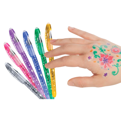 A hand with colorful temporary tattoo designs and the pens that made them.