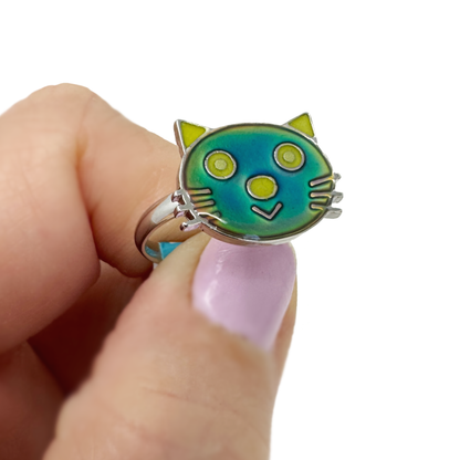 And hand holds a cute cat mood ring