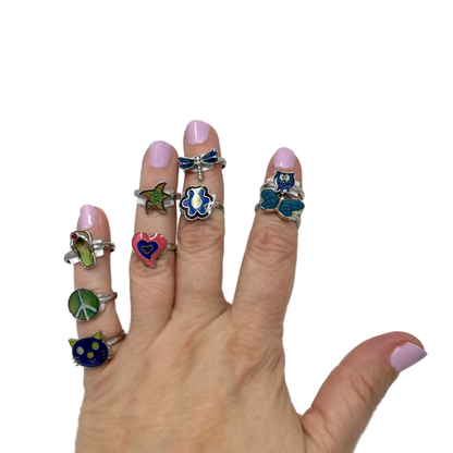 A hand wearing 9 Cutie Mood Rings