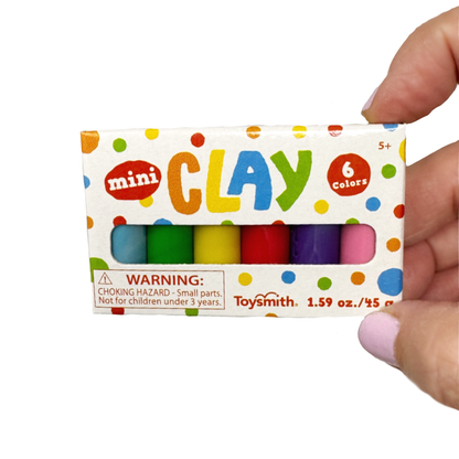 A hand holds a boxed set of mini clay in 6 colors.