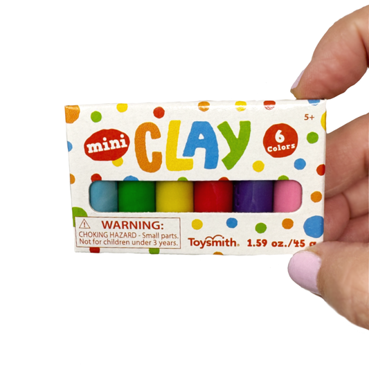 A hand holds a boxed set of mini clay in 6 colors.
