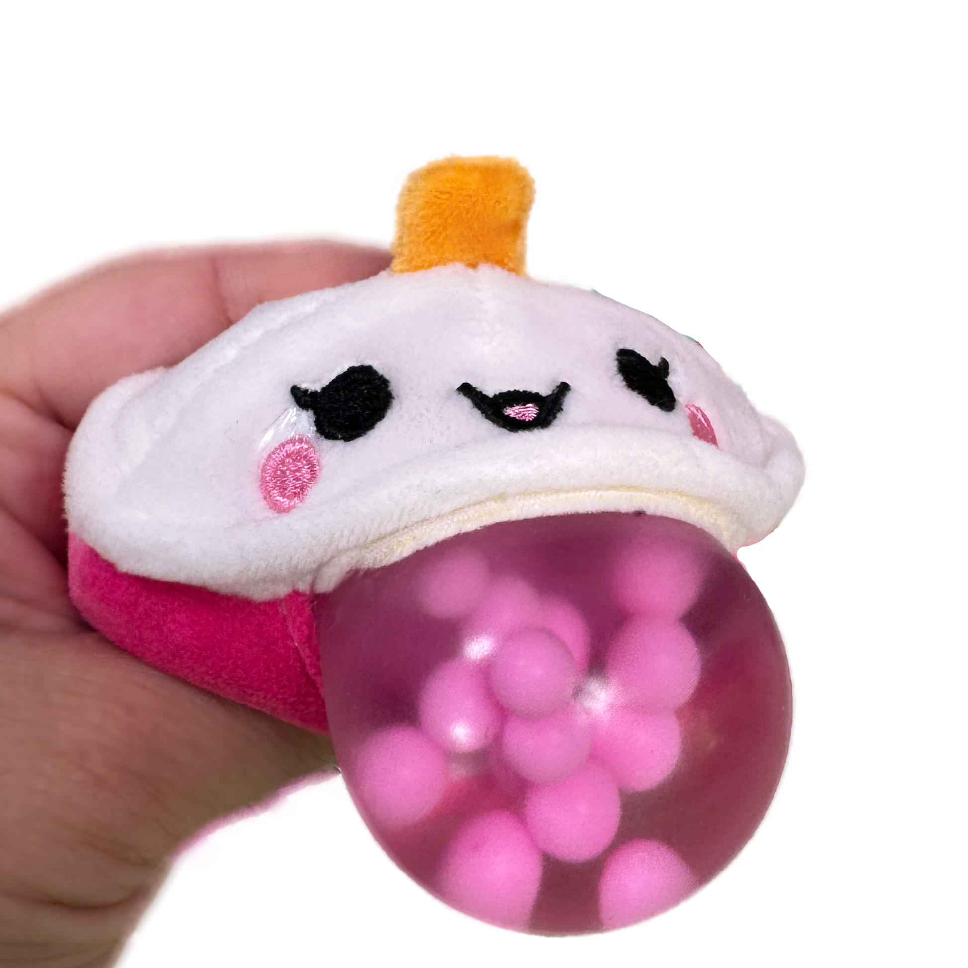 A hand squeezes a pink boba fidget toy with a kawaii plush face