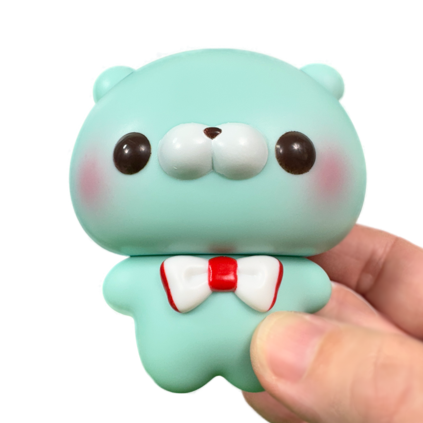 A hand holds a kawaii otter toy figure from the Sukkuto Tatchisan collection