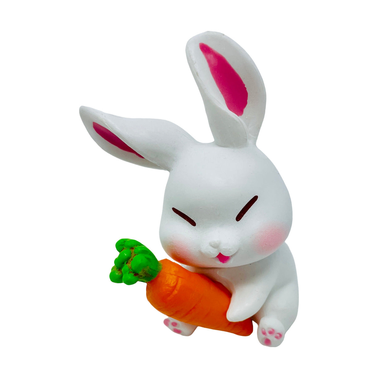 A  white toy bunny figurine holding a carrot.