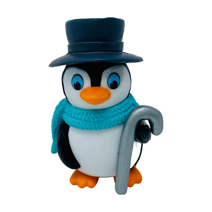 A toy penguin figurine with a top hat and a cane.