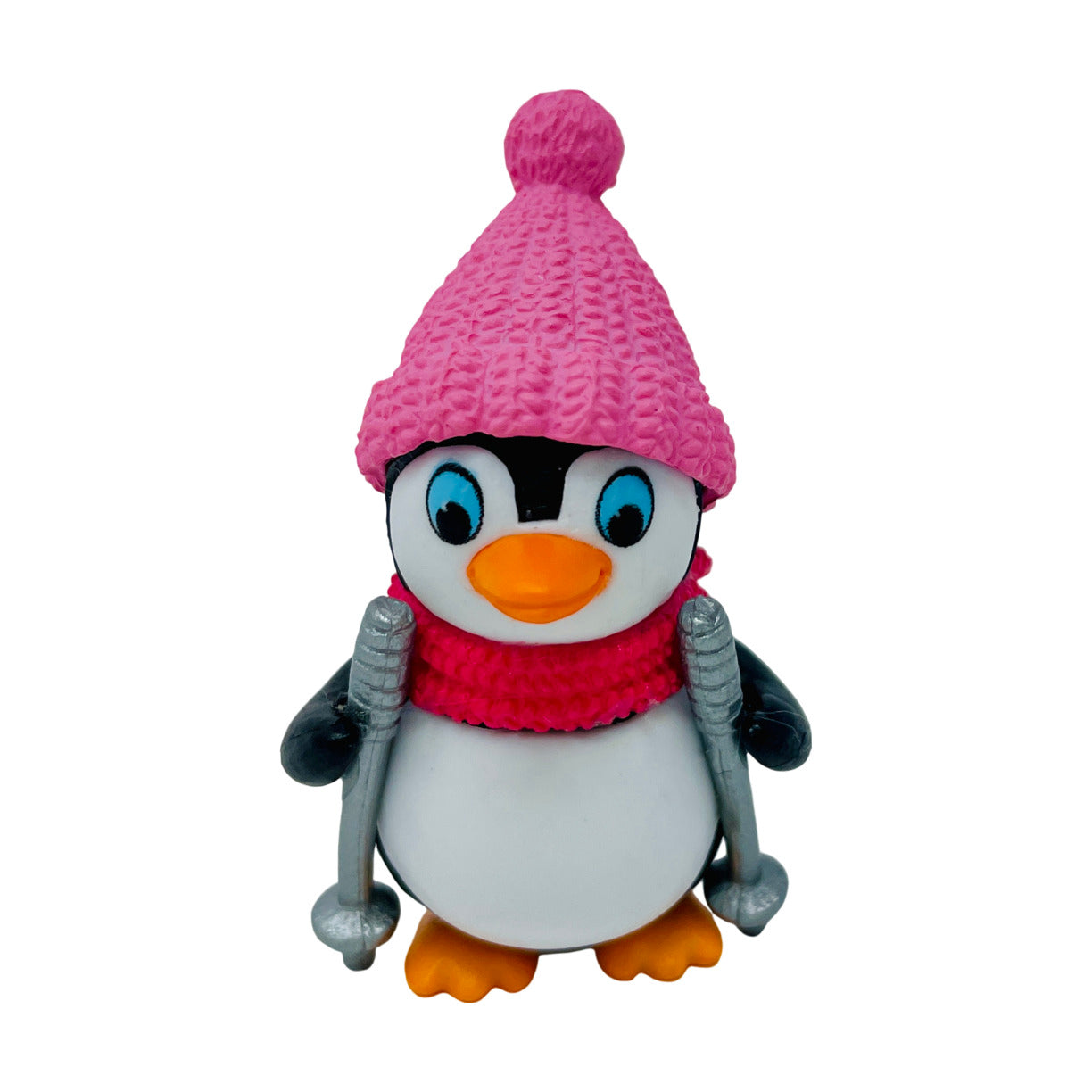 A toy penguin figurine with a pink hat and ski poles.