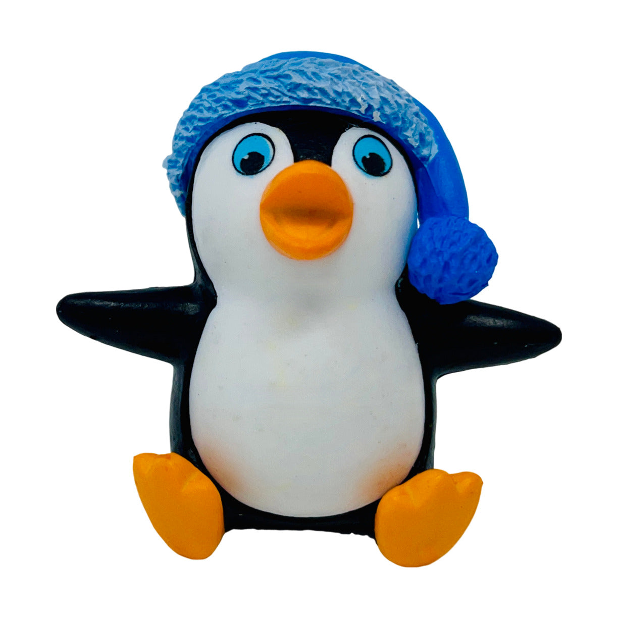 A toy penguin figurine with a blue hat.