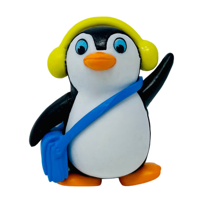 A toy penguin figurine with ear muffs.