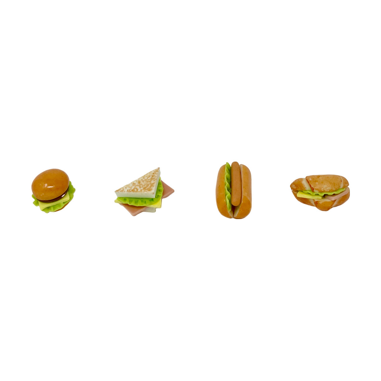 Four miniature toy sandwich figurines