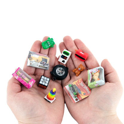 Two hands holding eleven of the micro toys available.