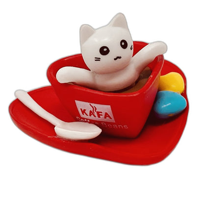 A toy figurine of a white toy cat with a red toy coffee cup.