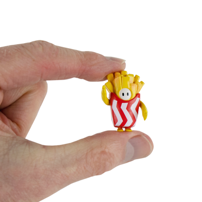 a hand holds a mini Fry Guy figurine from Fall Guys