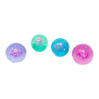 Four different colors of glittery toy bouncy balls with a toy axolotls  inside.