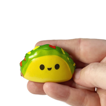 A handing holding a micro squishy taco fidget toy.